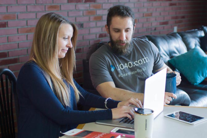 A couple researching Bitcoin at a coffee shop