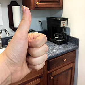 Thumbs up to saving money on caffeine boosts by drinking office coffee.