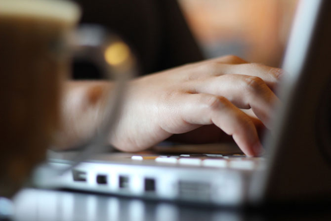 A taxpayer filing online using 1040.com at a coffee shop