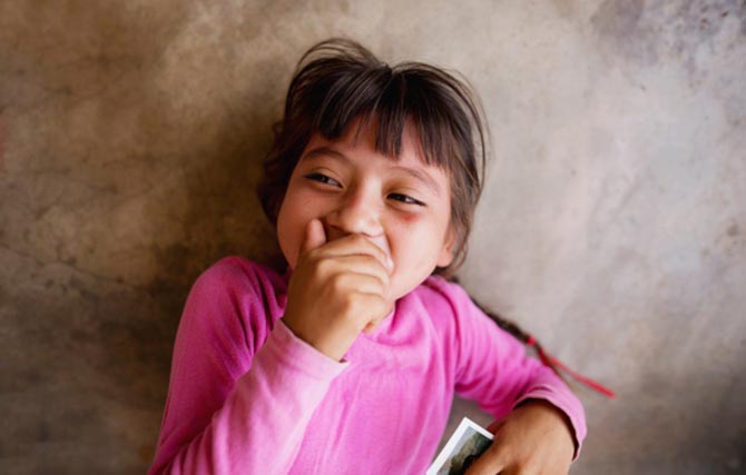 A little girl giggling on the floor