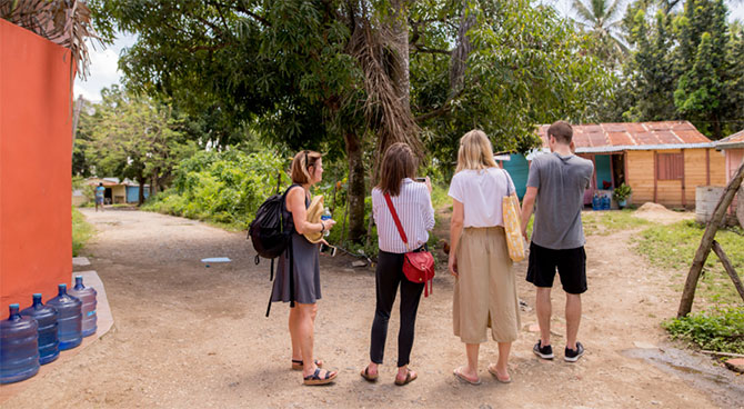 Part of the Healing Waters International team pauses to talk on a dusty street in the DR.