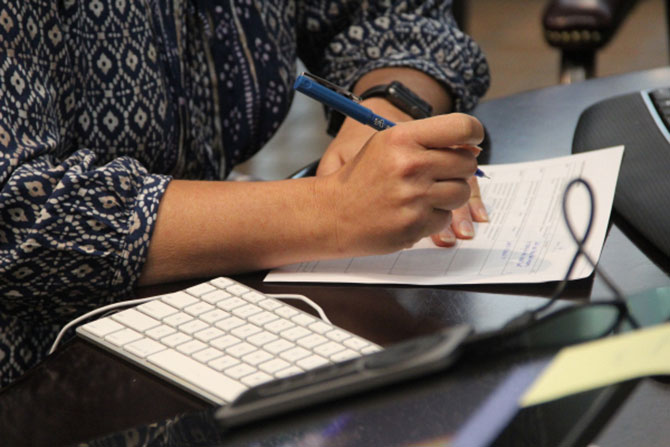 A woman reviewing her tax records as she files online with 1040.com