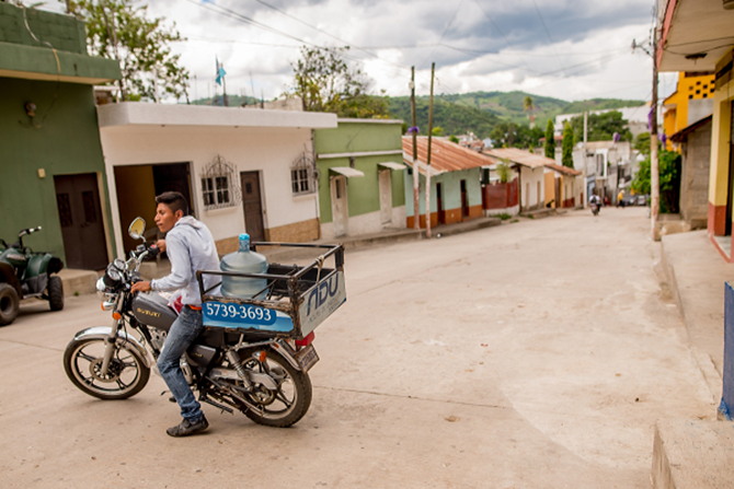 An HWI filtration system operator packing water onto a motorcycle