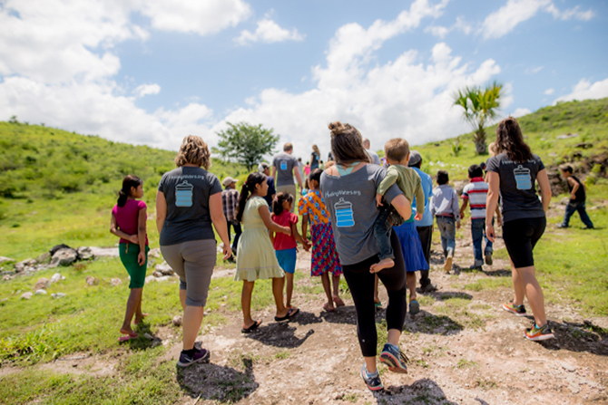 A group with Healing Waters International walking with children in Guatemala