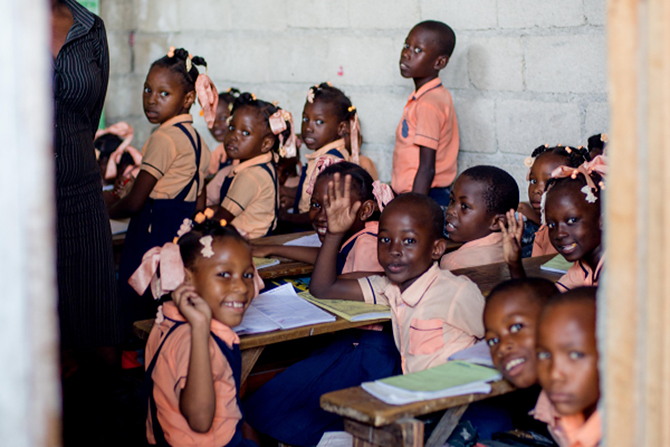 School children waving from their classroom in Haiti