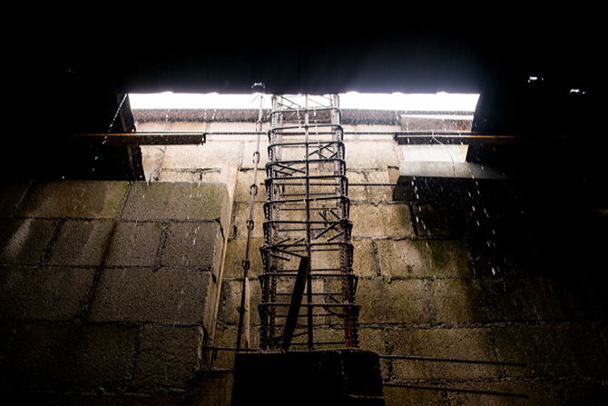 A rebar ladder drenched in rainwater