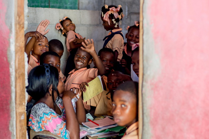 Schoolchildren in Haiti, waving to visitors