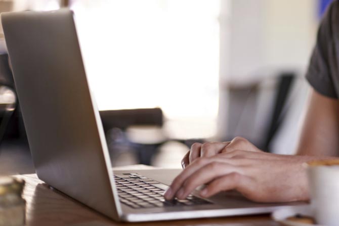 A man using a laptop over coffee