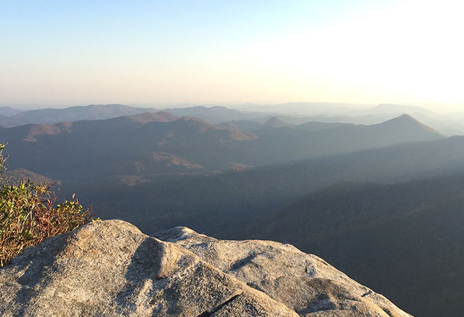 Sunbeams glide through the Blue Ridge mountains from an overlook.