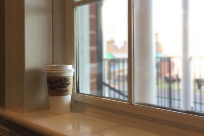 A coffee cup on a window sill
