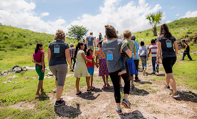 Healing Waters International and 1040.com walk through Jocotan with local children.