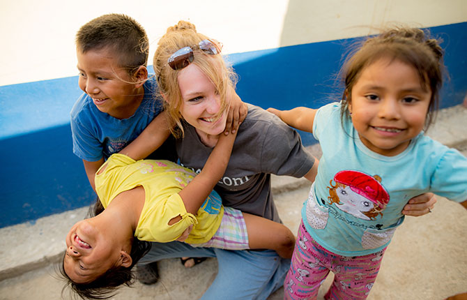 Delainie Golightly plays with children in the streets of Guatemala City.
