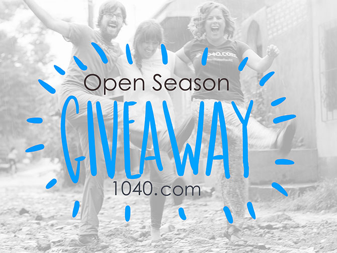 Three people laughing and dancing in the rain for an open season giveaway.