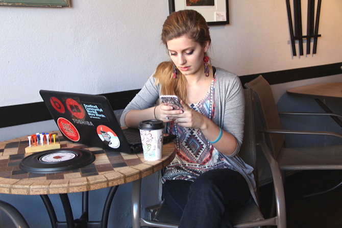 A woman looks up the PATH Act in a coffee shop.