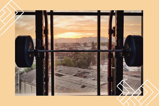 A weight rack and a city view