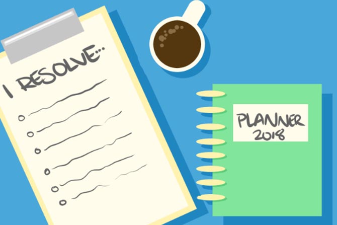 A list of resolutions beside a planner and a cup of coffee
