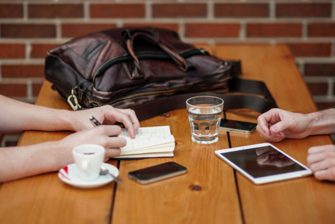 College students doing homework in a coffee shop.