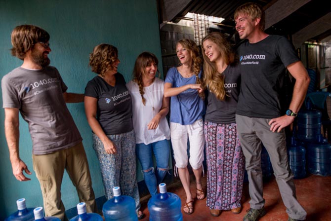 A group of 1040.com employees laughing and posing for a group photo