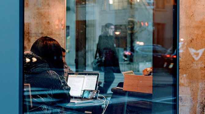 A woman filing her taxes late at a café