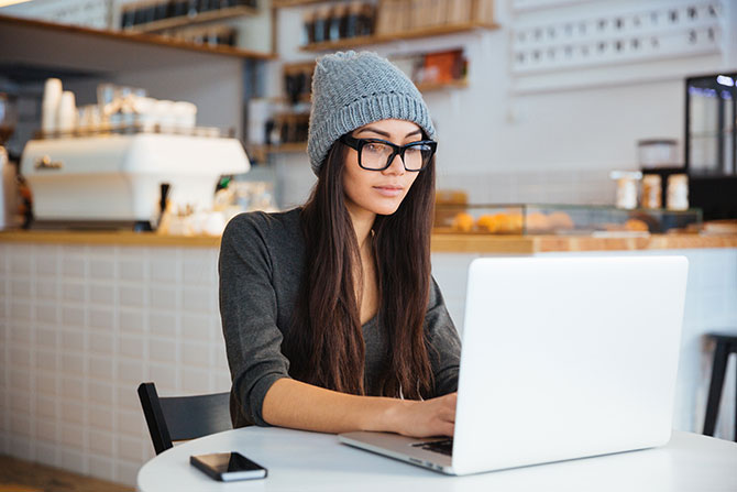 A woman using a laptop in a café