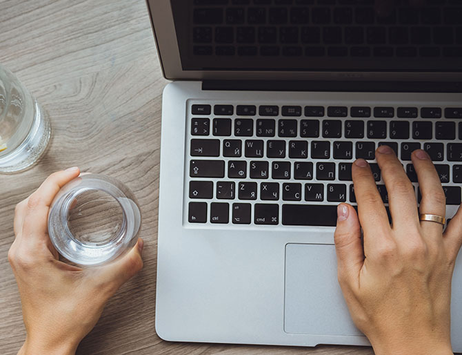 A woman typing on a laptop