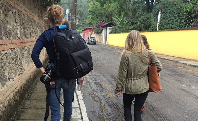 Women  walk  on a path with water bottles and backpacks