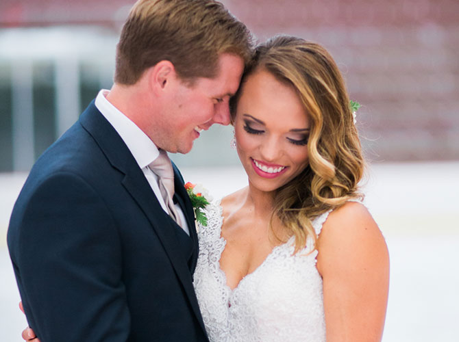 Newlyweds pose for their wedding photographer.