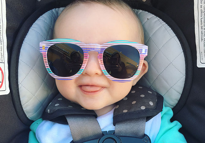  A grinning baby girl in sunglasses