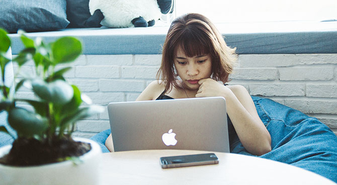 A woman e-filing her taxes on her laptop