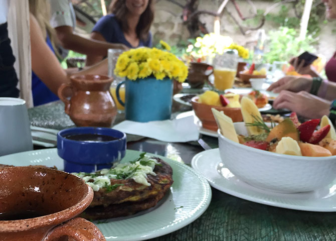 A group of friends enjoy breakfast at a small business owner’s restaurant.]