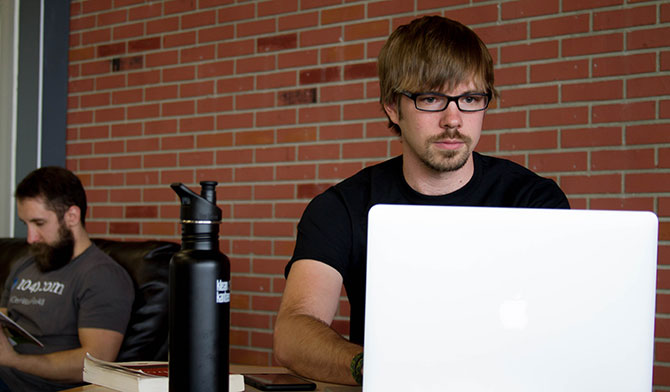 A man using a laptop in a coffee shop