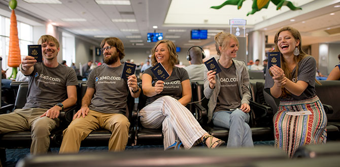 Five 1040.com employees hold up their passports on a trip to Guatemala.