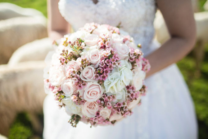A July bride shows off her bouquet.