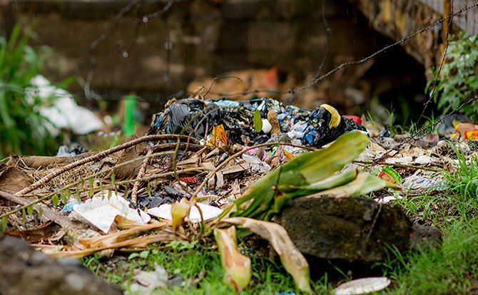 Trash piled up next to the clogged river in Portales, Guatemala